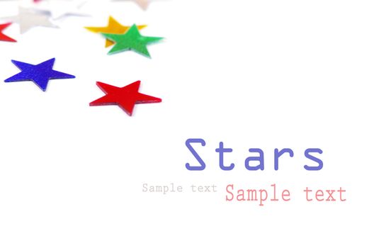 Christmas decoration of colored confetti stars against white background