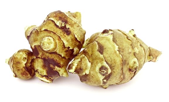 Two tubers of jerusalem artichoke on white background
