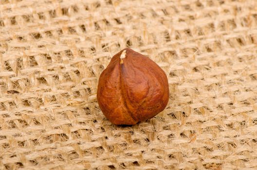 Hazelnuts on burlap background