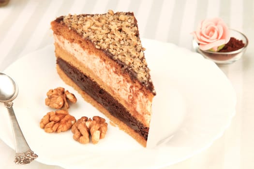 chocolate cake on the white plate with a silver spoon