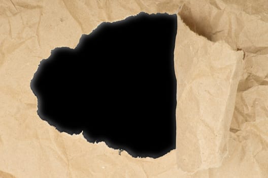 ripped white paper against a black background
