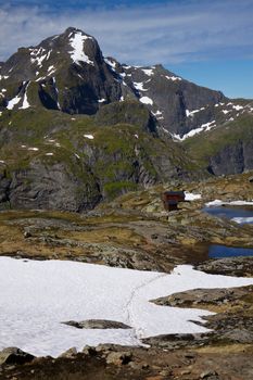 Picturesque highest peaks on Lofoten islands in Norway with mountain hut