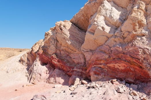 Striped pink rock in stone desert in Large Crater (Makhtesh Gadol) in Israel