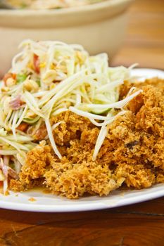 Green papaya salad and fried catfish is delicious Thai food