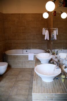 Interior of elegant modern bathroom with luminous lamps