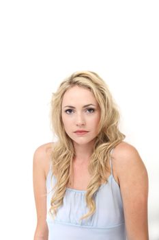 Wistful withdrawn young woman with a sad expression and hunched shoulders isolated on white 