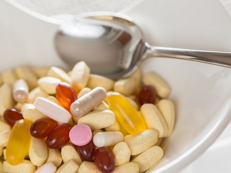 Vitamins in bowl of tablets for breakfast in kitchen