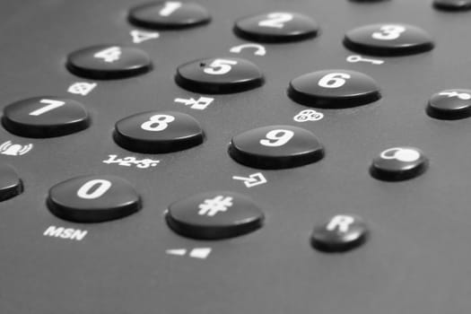 dark telephone keypad closeup with white numbers