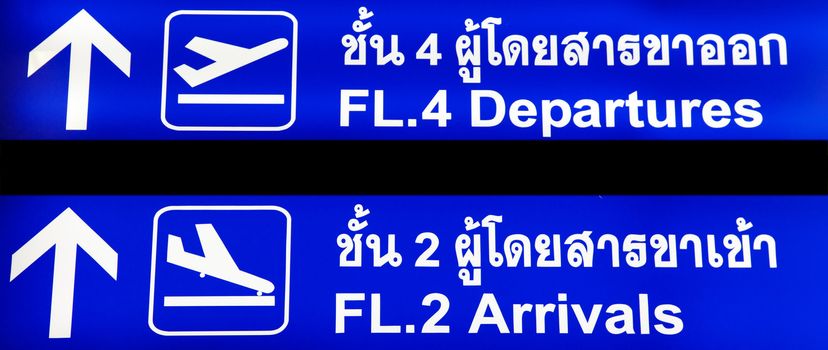 Blue airport sign with arrivals and departures in Thailand