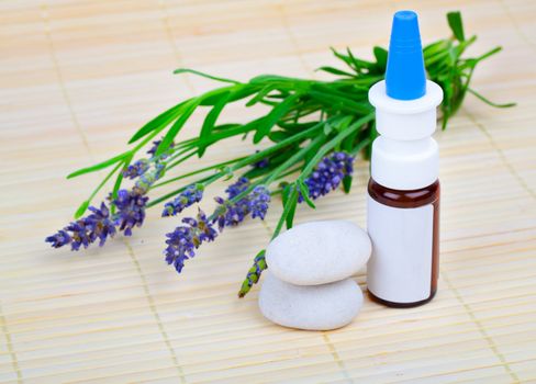 Lavender herb flower leaf springs with an aromatherapy essential oil dropper bottle.