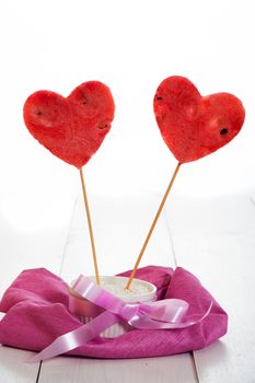 two watermelon heart as lollipop on white background as a studio shot