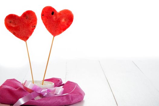 two watermelon heart as lollipop on white background as a studio shot