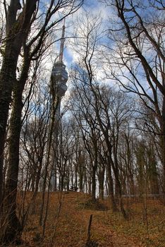 Avala tower on high hill between trees at autumn in Belgrade, Serbia