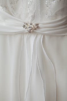 part of a wedding dress with brooch