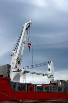 Two ship cranes on a deck of the cargoship