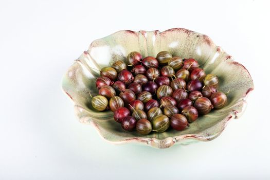 Fresh gooseberry in bowl on white background