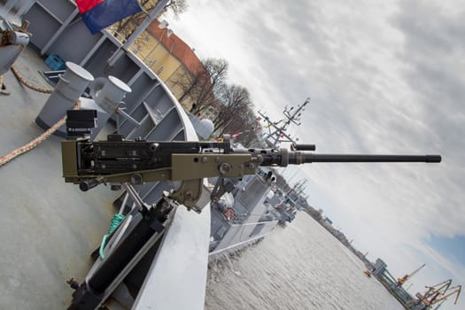 machine gun on warship against dark sky