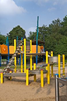 Sand and water playground for children in public park in summer - vertical 