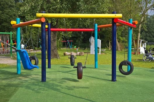Colorful swings at playground in public park