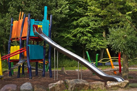 High sliding- and climb construction in public park in summer