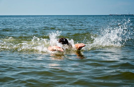 Young male swimming in the sea/ocean