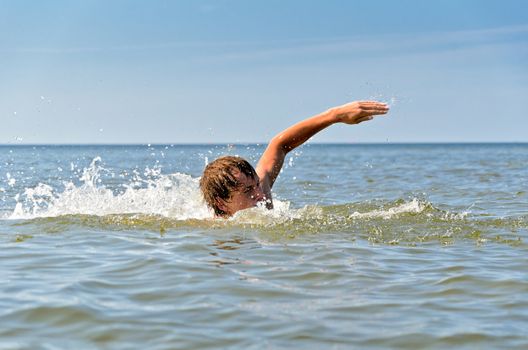 Young male swimming in the sea/ocean