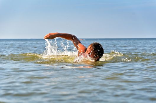 Young male swimming in the sea/ocean