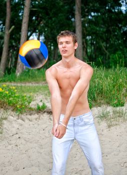 Young man playing volleyball on the beach