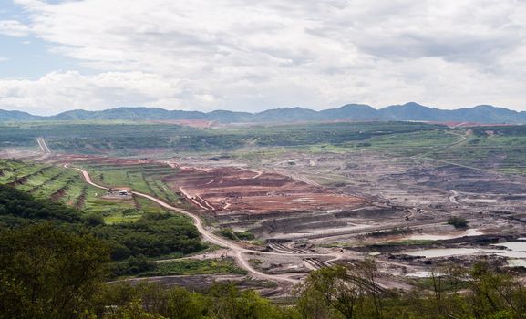 Lanscape of coalmine with cloudy and mountain in daylight time