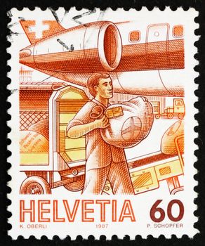 SWITZERLAND - CIRCA 1987: a stamp printed in the Switzerland shows Loading Airmail, Mail Handling, circa 1987