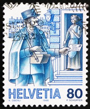 SWITZERLAND - CIRCA 1986: a stamp printed in the Switzerland shows Postman, 1900, Mail Handling, circa 1986