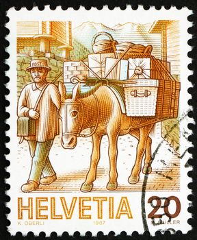 SWITZERLAND - CIRCA 1987: a stamp printed in the Switzerland shows Mule Post, Mail Handling, circa 1987
