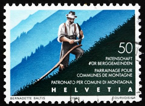 SWITZERLAND - CIRCA 1990: a stamp printed in the Switzerland shows Mountain Farmer Cuts Grass, Assistance for Mountain Communities, 50th Anniversary, circa 1990