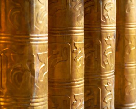 Buddhist prayer wheels decorated in Tibet monastery temple