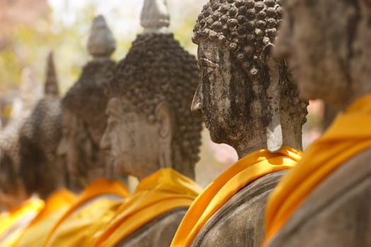 Buddha statue at Wat Yai Chai Mongkol in a row Ayutthaya in Thai