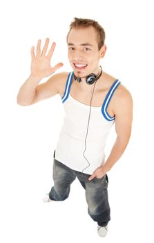 Smiling handsome young man in casual style with headphones shows hello by his hand, isolated on white background