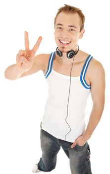 Smiling handsome young man in casual style with headphones shows sign freedom, isolated on white background