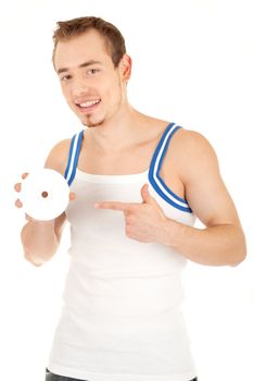 Handsome smiling young man in T-shirt is showing a compact disk. Isolated on white background