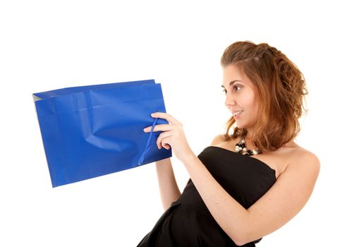 Beautiful women in black dress with blue papper bag try to discover what is inside the bag.