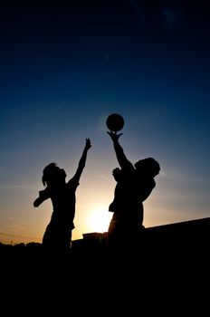 silhouette of man playing basketball