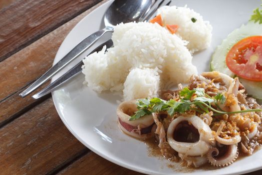 Squid fried with garlic and rice in pattern bear on white plate