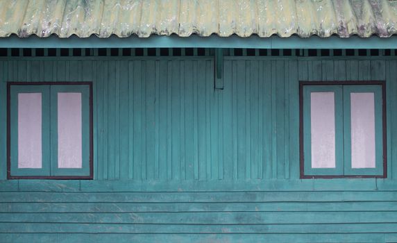 two window on blue wood wall