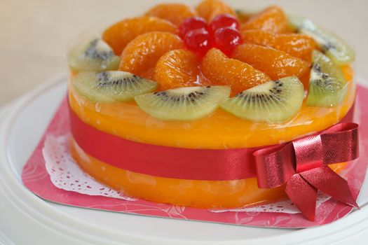 mixed fruit with orange jam cake and pink ribbon