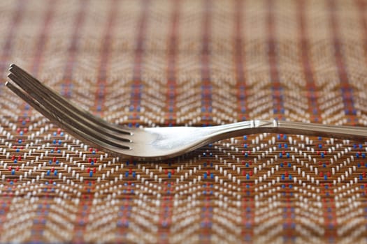 A fork on brown napkin