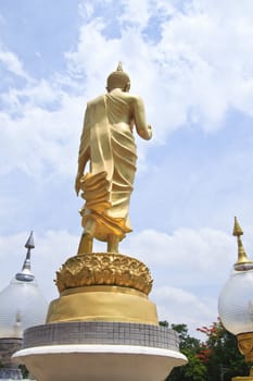 backside Buddha statue against blue sky