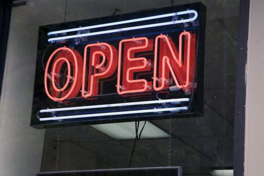 Neon sign informing customers that shop is open for business.