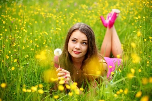 summer woman blow on dandelion 