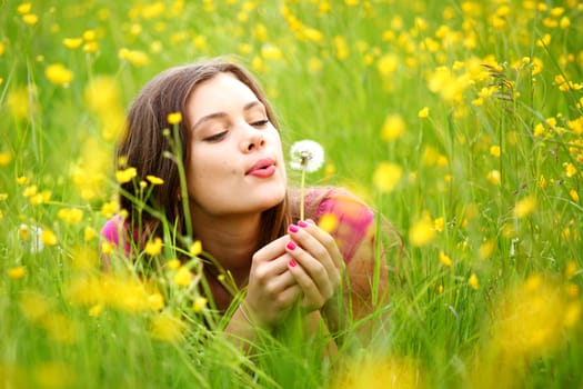 summer woman blow on dandelion 