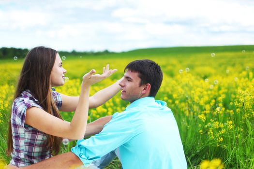 lovers hug on yellow flower field
