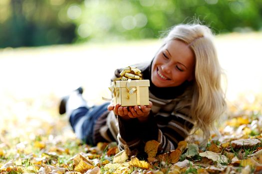 woman take autumn gift in park